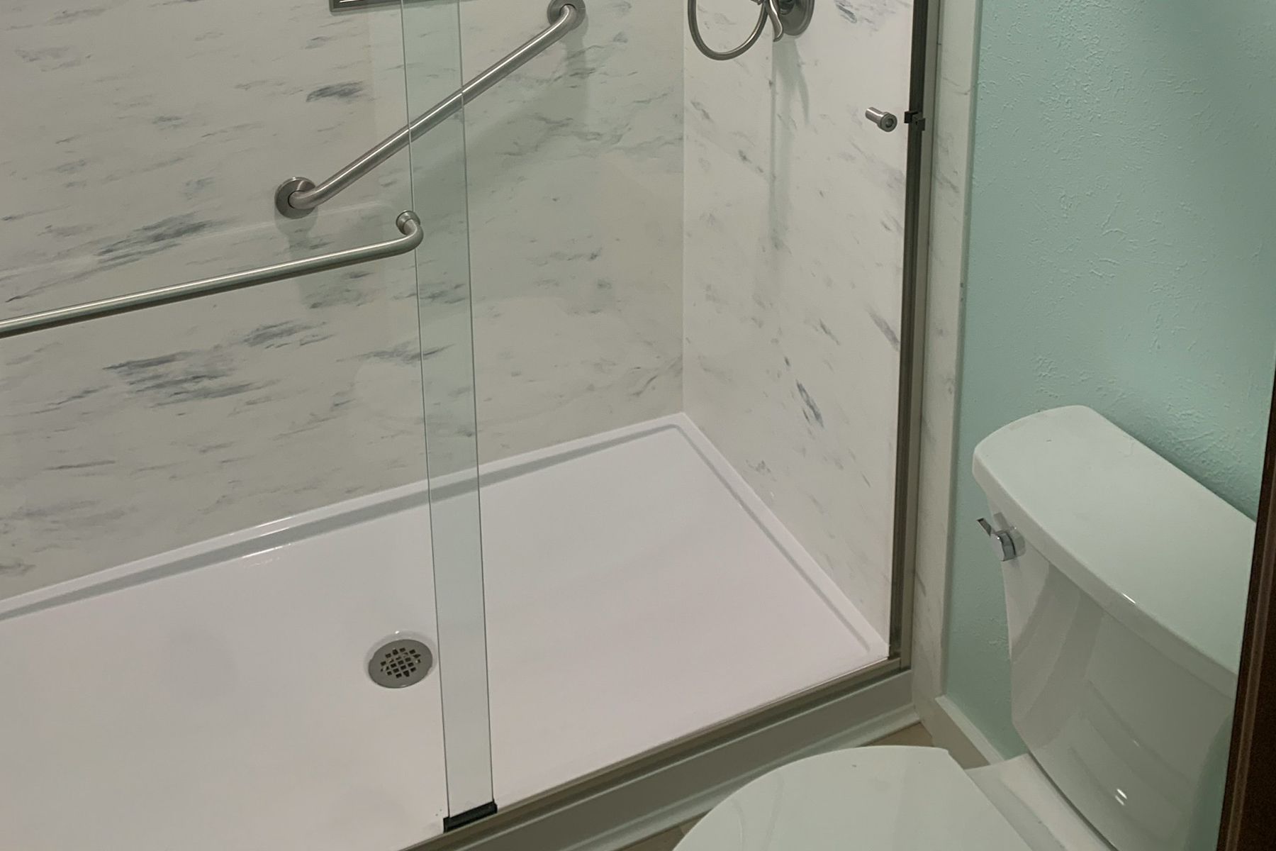 Dusche wird mit Reinigungsmittel gesäubert